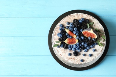 Delicious homemade cake with fresh berries and space for text on wooden table, top view