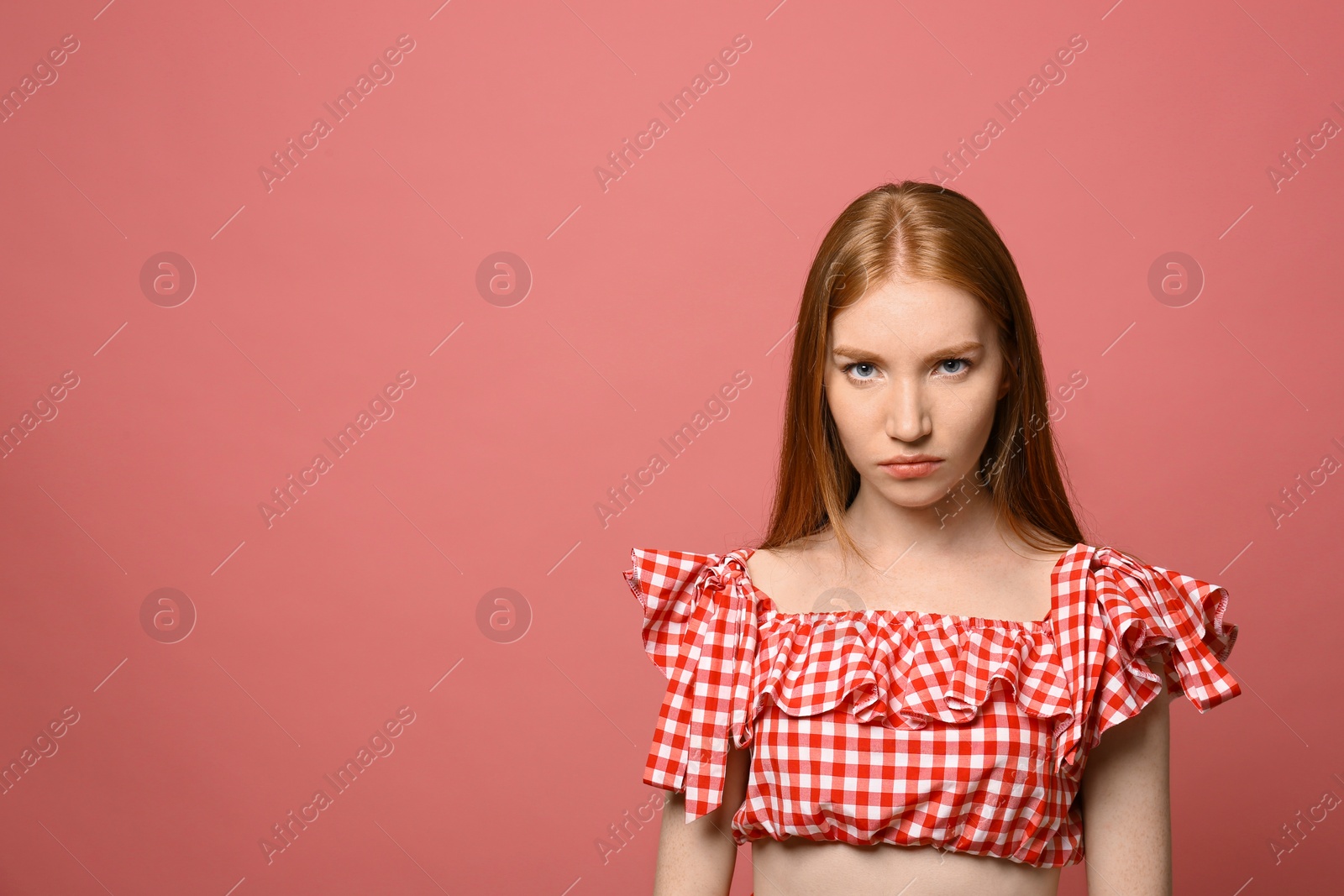 Photo of Portrait of angry young woman on pink background