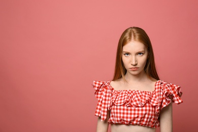 Photo of Portrait of angry young woman on pink background