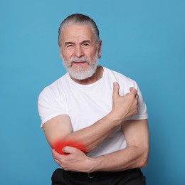 Image of Senior man suffering from rheumatism on light blue background