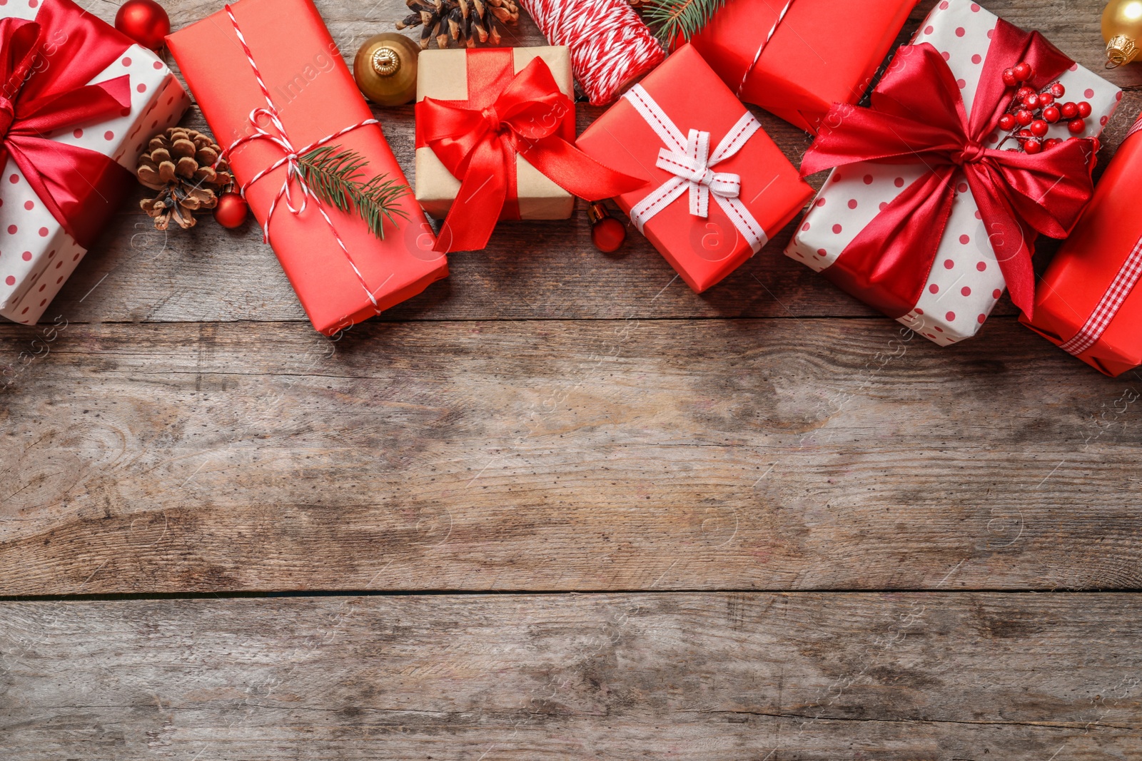 Photo of Beautiful composition with gift boxes and Christmas decorations on wooden background, top view