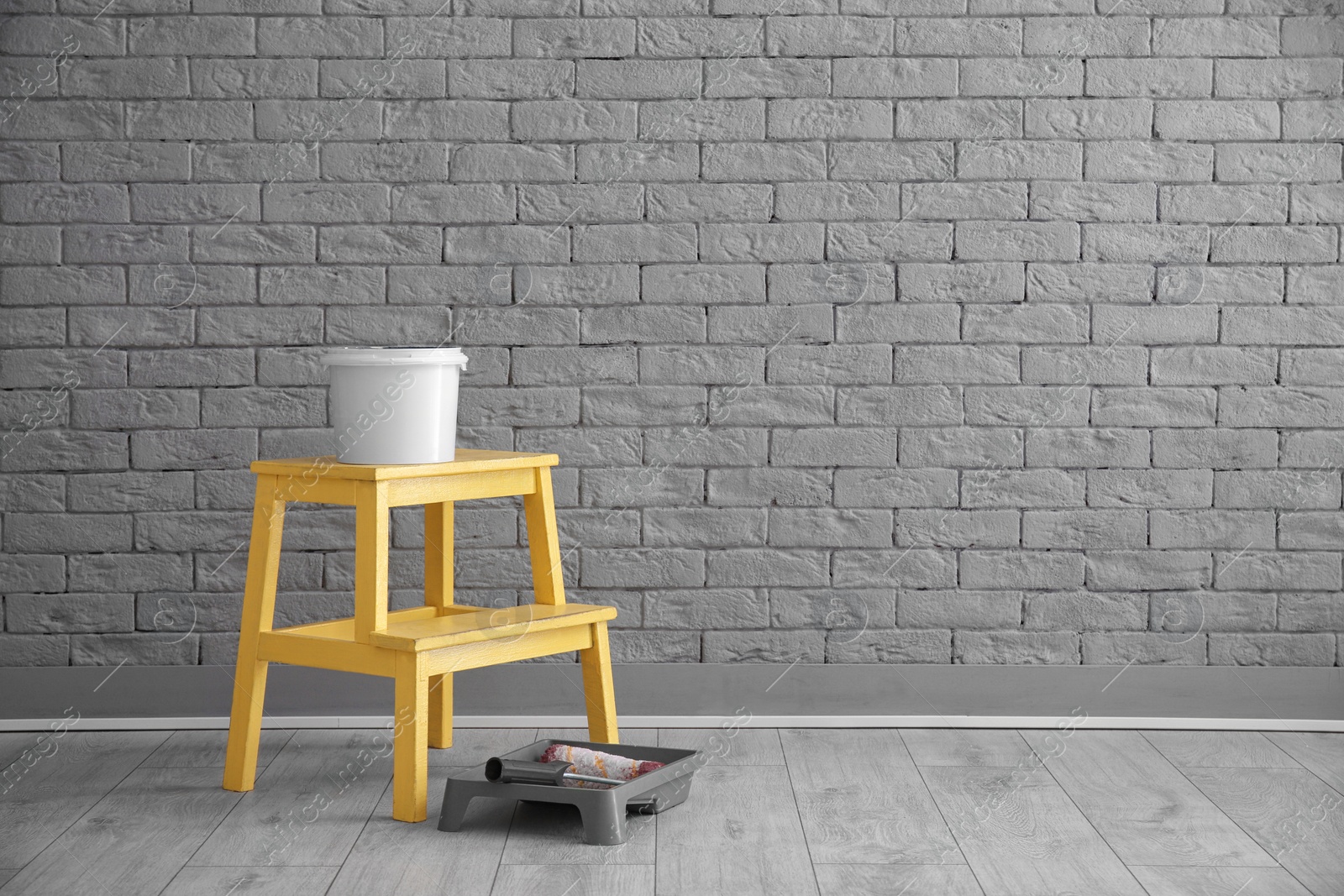 Photo of Decorator's tools near brick wall