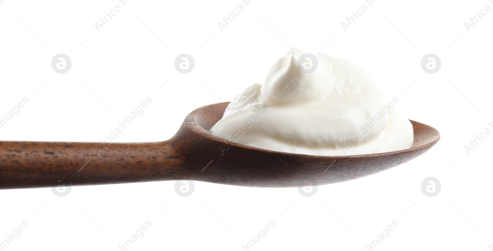 Photo of Wooden spoon with sour cream on white background