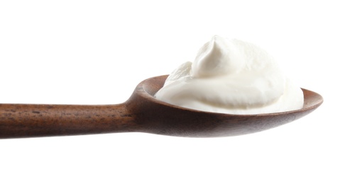 Photo of Wooden spoon with sour cream on white background