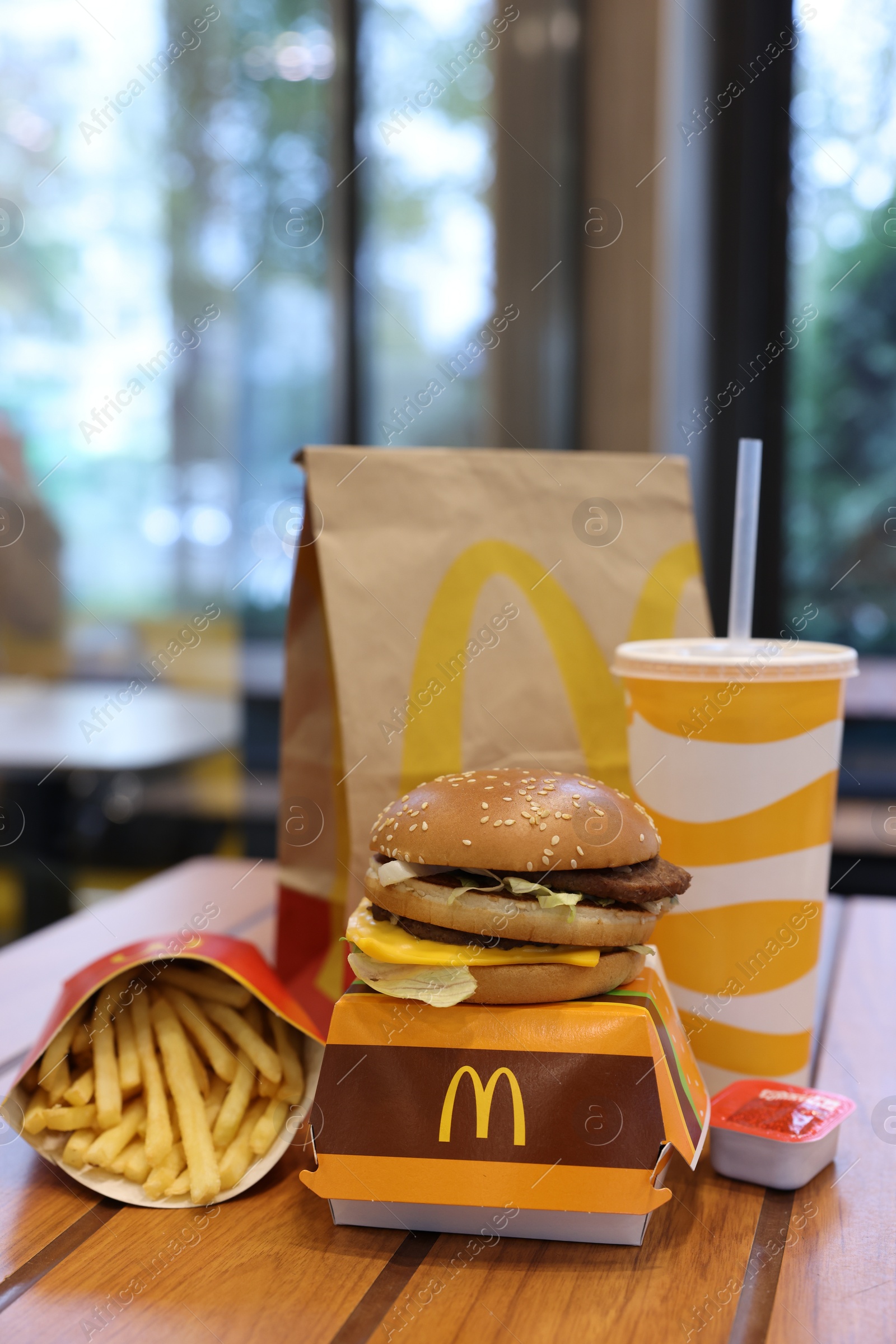 Photo of Lviv, Ukraine - October 9, 2023: McDonald's menu on wooden table in restaurant