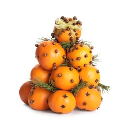 Pomander balls made of tangerines with cloves and fir branches on white background