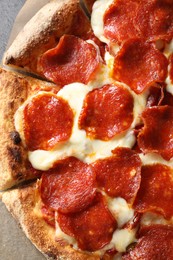 Photo of Tasty pepperoni pizza on grey table, top view