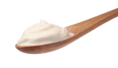 Photo of Delicious sour cream in wooden spoon on white background