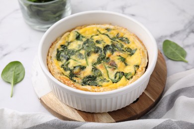 Photo of Delicious pie with spinach on white marble table, closeup