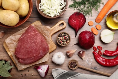 Fresh ingredients for borscht on wooden table, flat lay