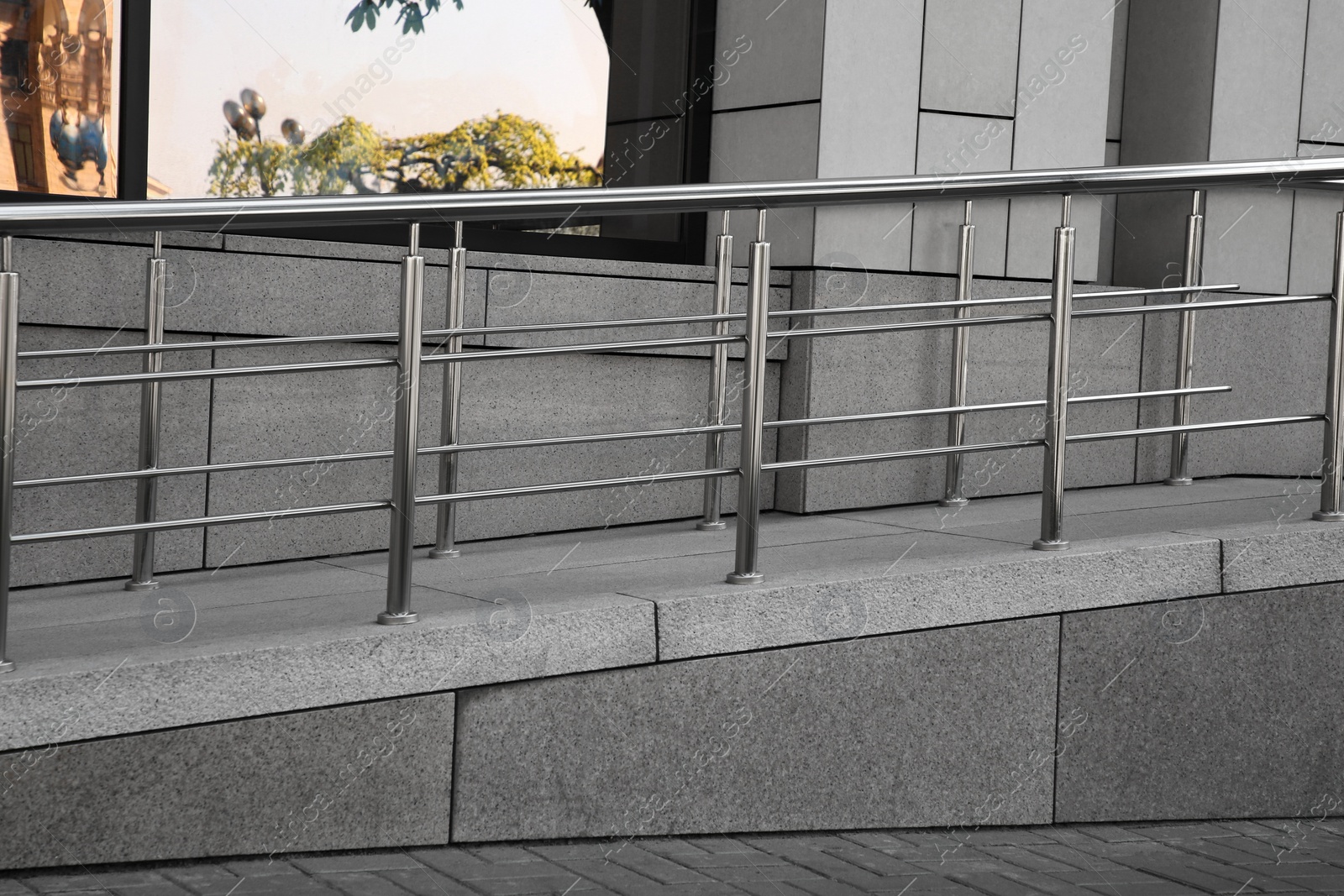 Photo of Ramp with metal handrails near building outdoors