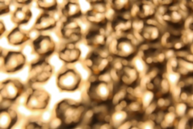 Photo of Blurred view of golden bubble wrap as background
