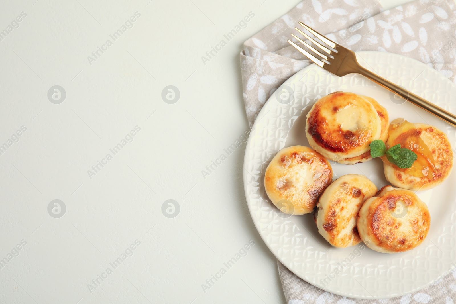 Photo of Delicious cottage cheese pancakes on white table, flat lay. Space for text
