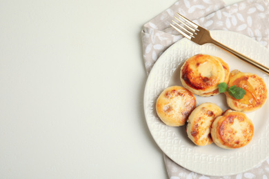 Delicious cottage cheese pancakes on white table, flat lay. Space for text