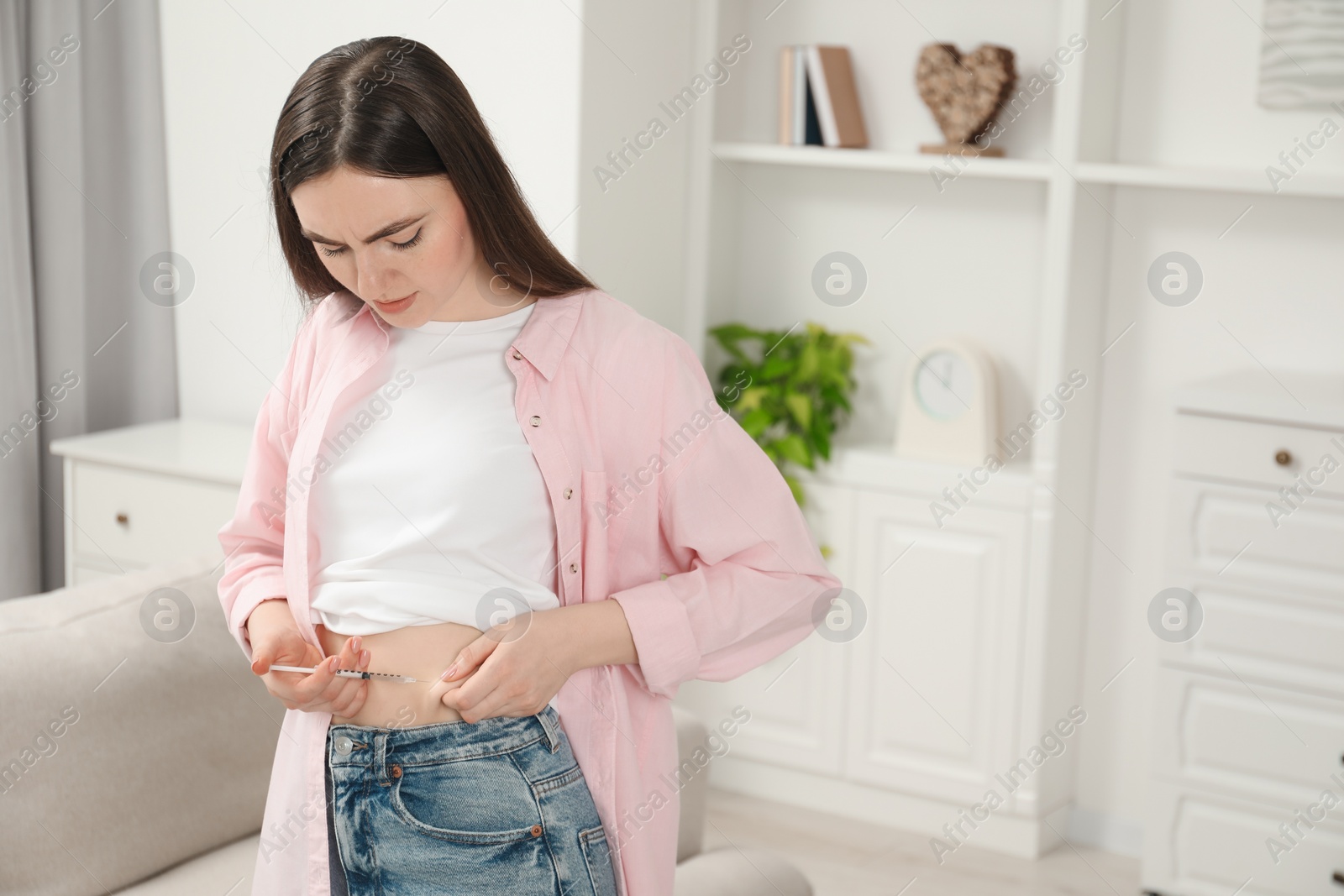 Photo of Diabetes. Woman making insulin injection into her belly at home, space for text