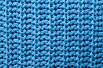 Photo of Beautiful light blue knitted fabric as background, top view