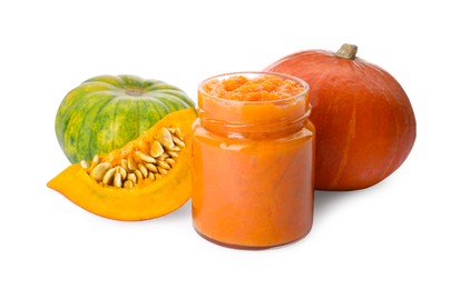 Photo of Jar of pumpkin jam and fresh pumpkins on white background