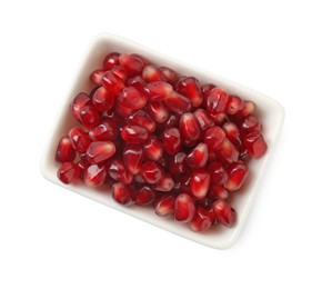 Ripe juicy pomegranate grains in bowl isolated on white, top view
