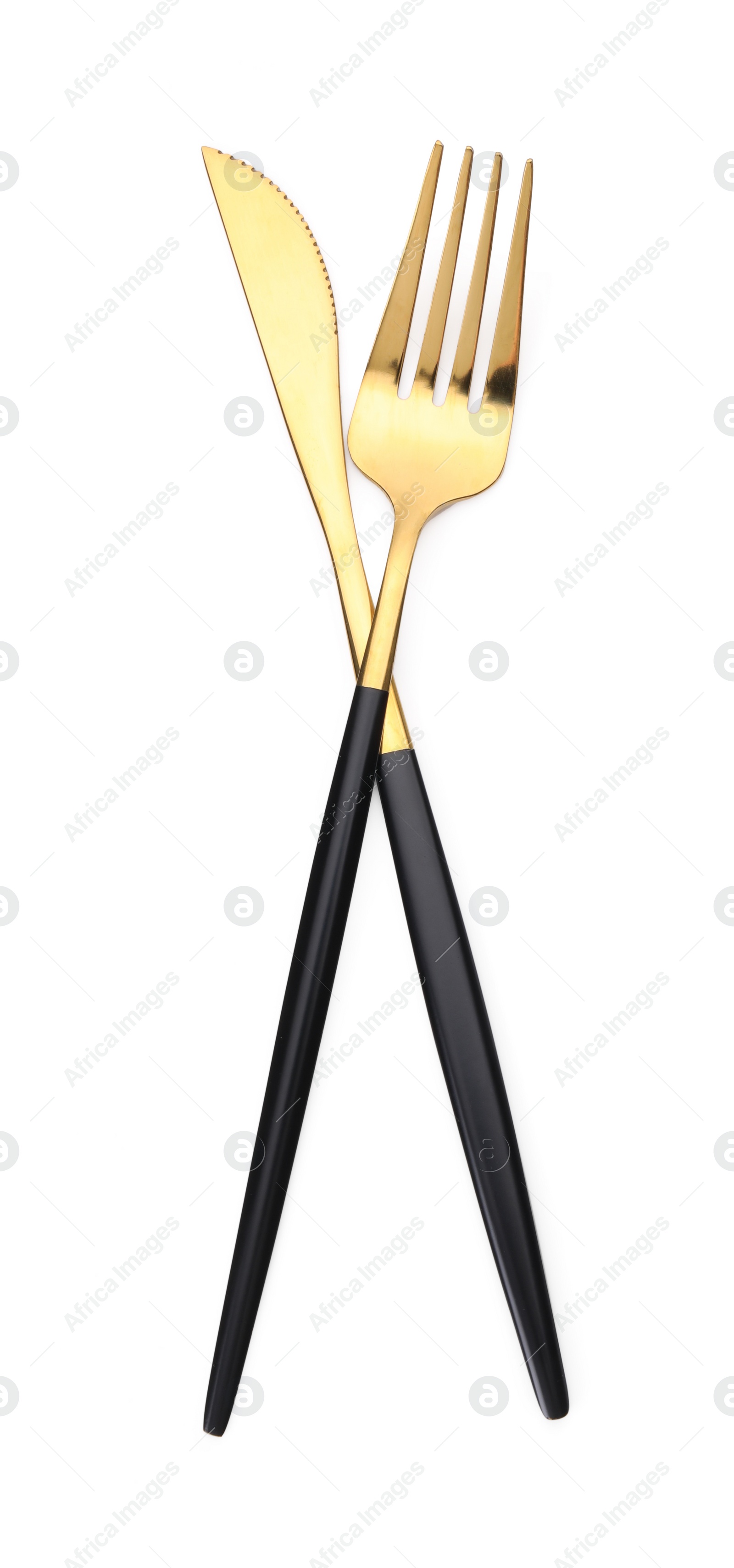 Photo of Shiny golden fork and knife isolated on white. Luxury cutlery