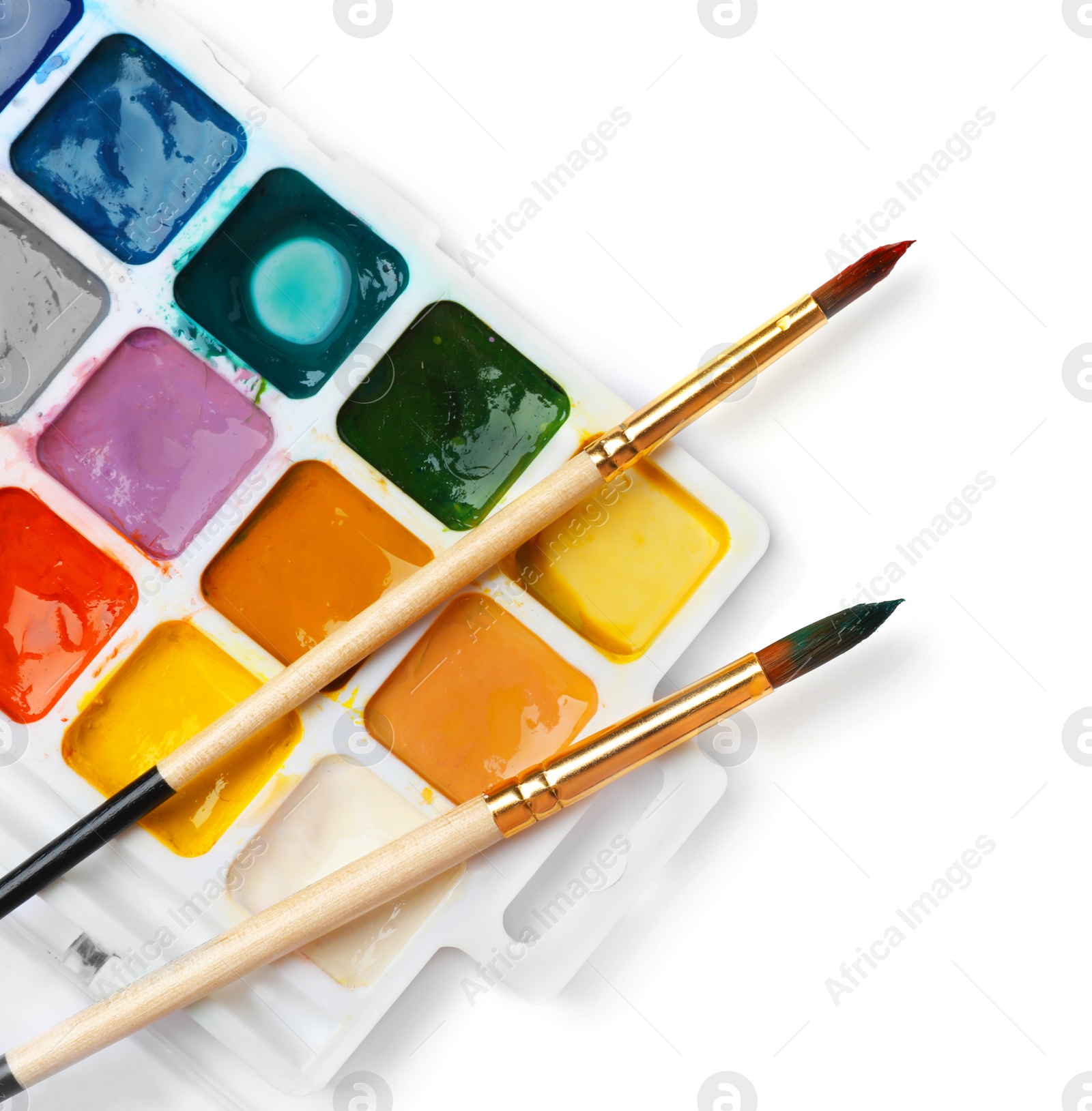 Photo of Plastic palette with colorful paints and brushes on white background, top view