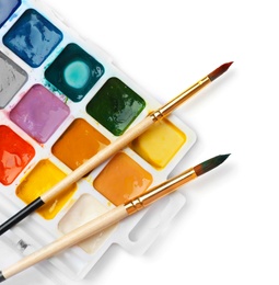 Plastic palette with colorful paints and brushes on white background, top view