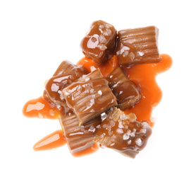 Photo of Delicious salted caramel with sauce on white background, top view