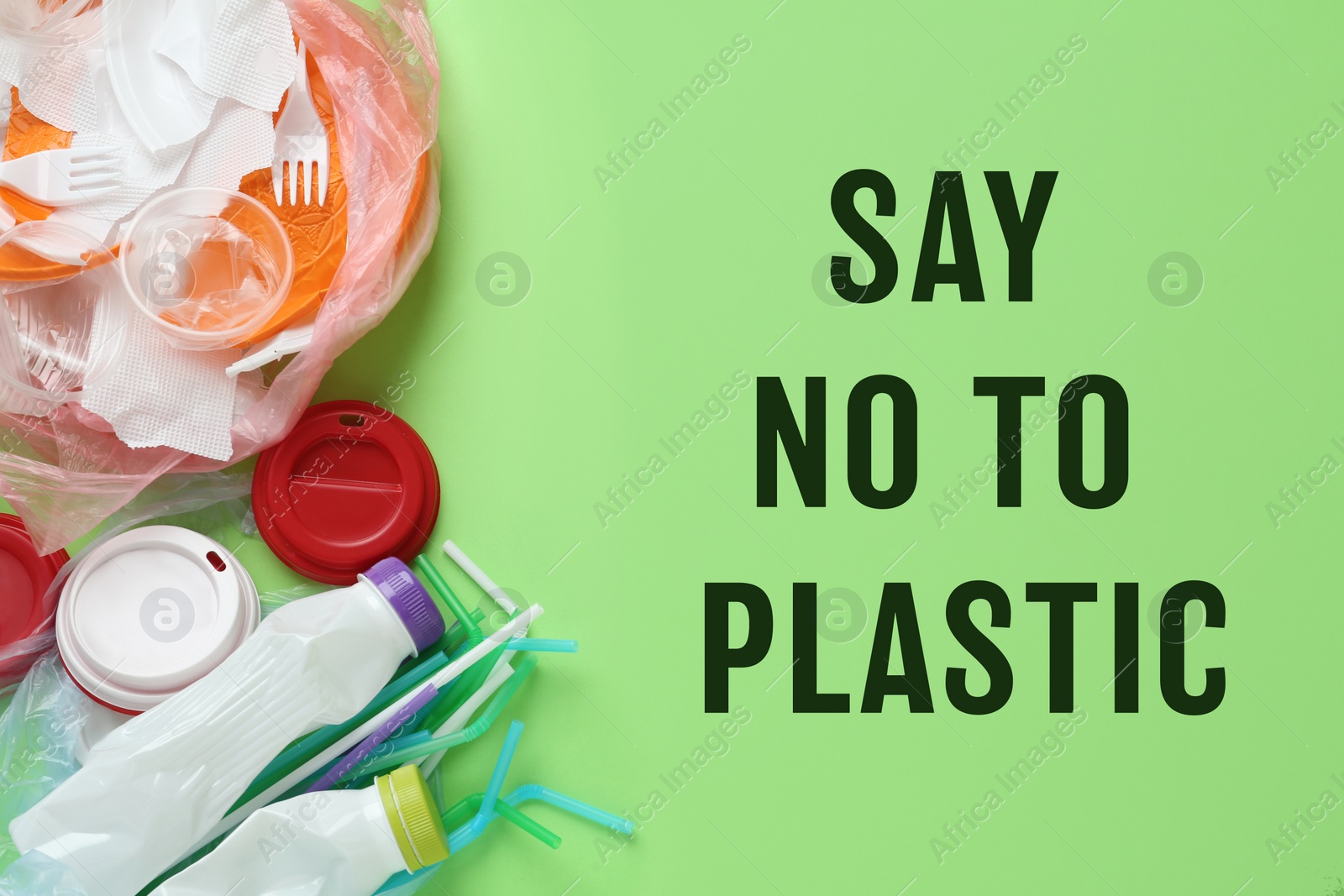 Image of Text SAY NO TO PLASTIC and disposable items on green background, flat lay