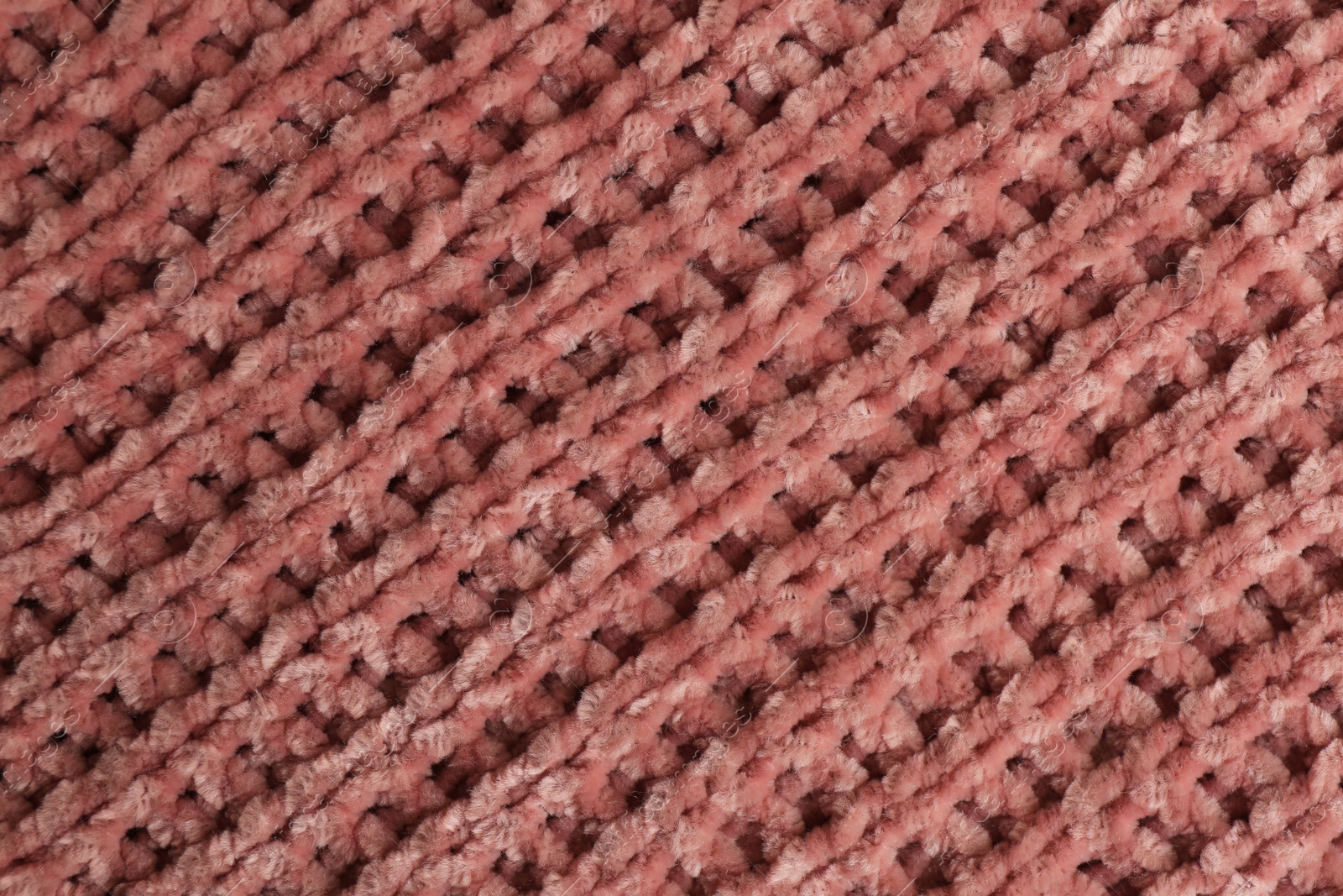 Photo of Beautiful pink knitted fabric as background, top view