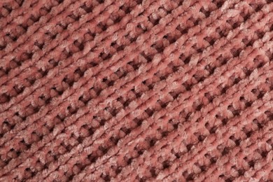 Beautiful pink knitted fabric as background, top view