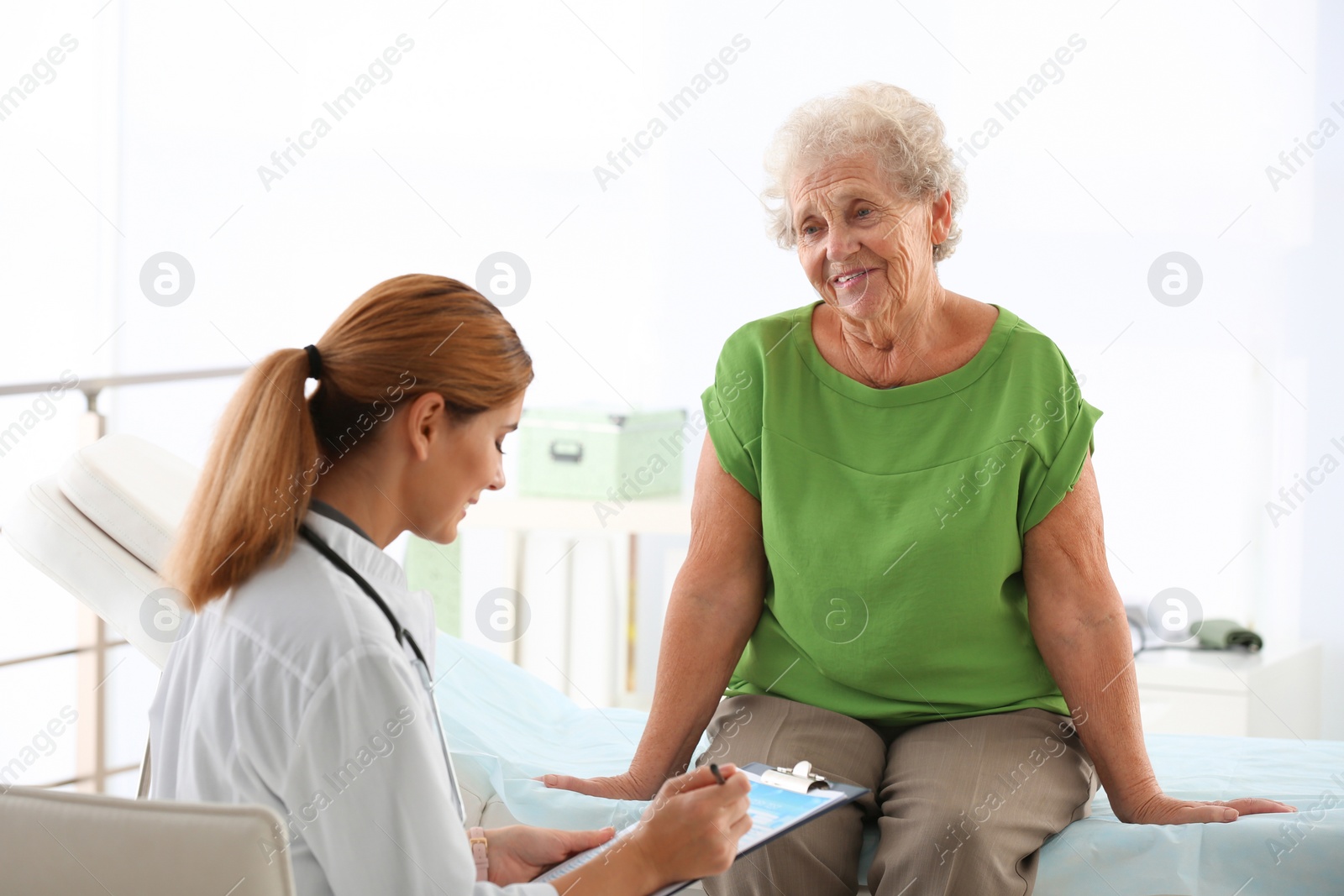 Photo of Doctor working with elderly patient in hospital