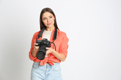 Photo of Professional photographer working on white background in studio