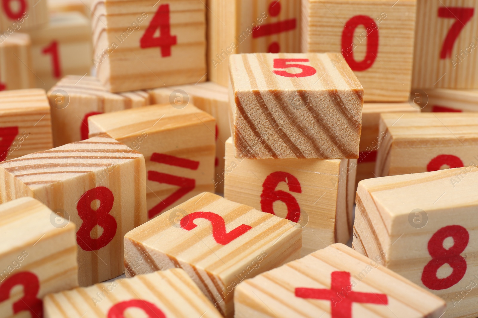 Photo of Wooden cubes with numbers and mathematical symbols, closeup