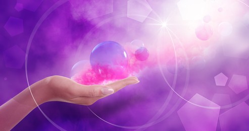 Image of Concept of karma. Woman holding images of spheres and pink smoke on color background, closeup