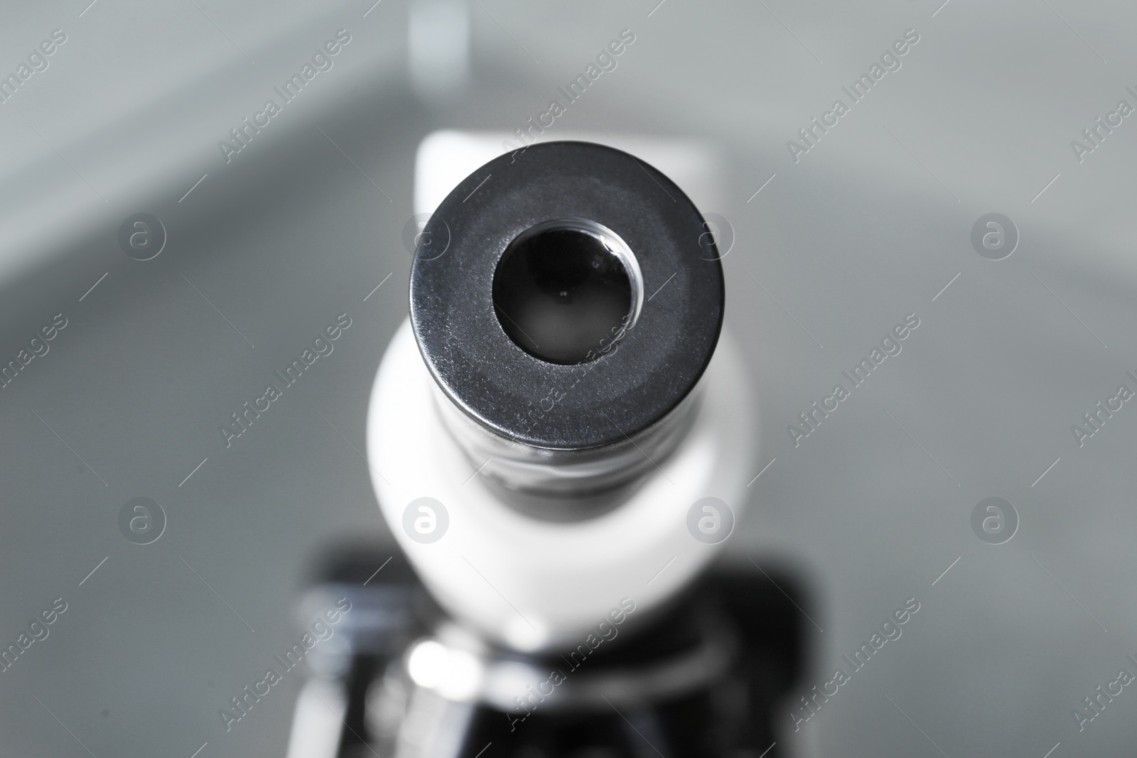 Photo of Closeup view of modern medical microscope on blurred background