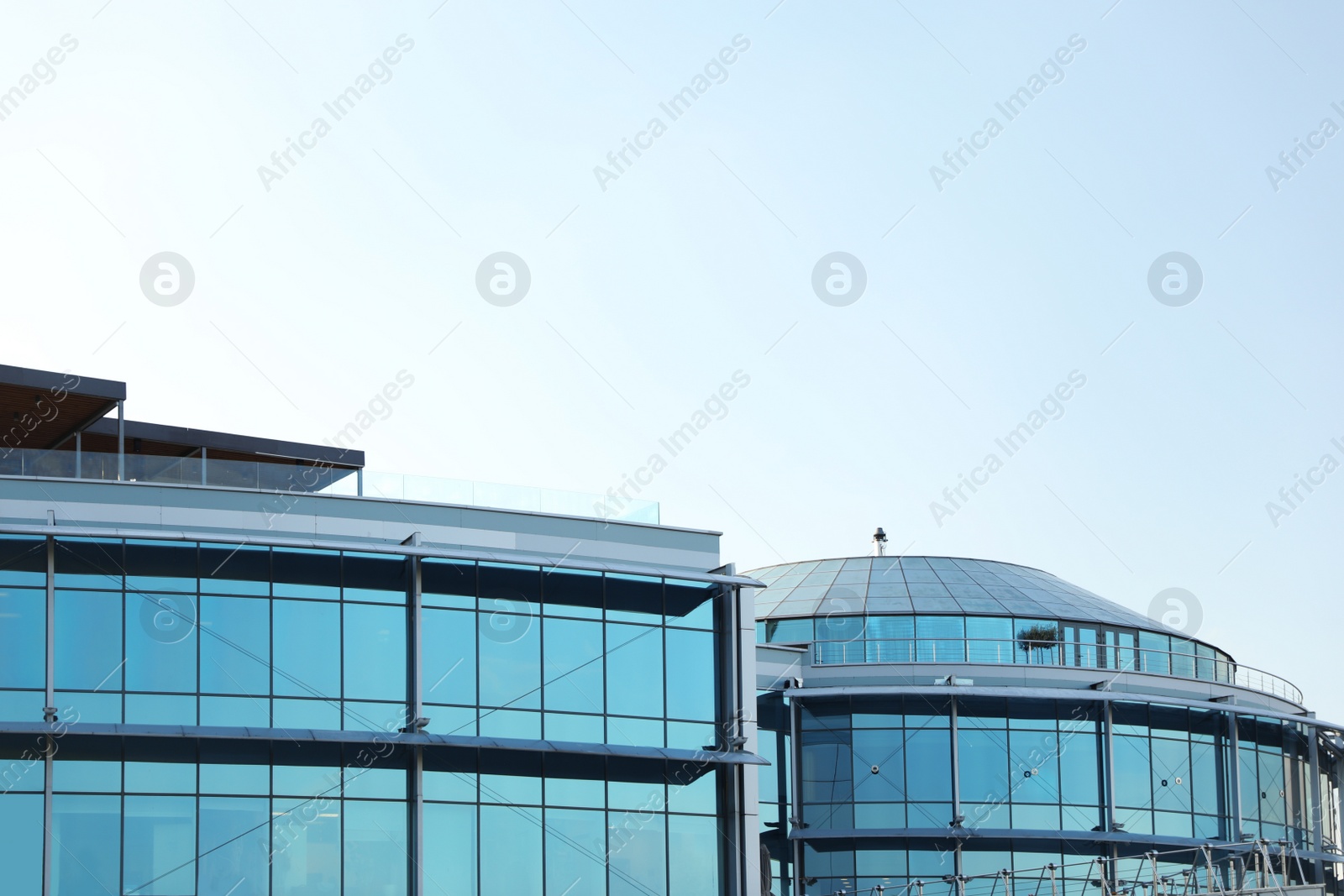 Photo of Modern building with tinted windows against sky. Urban architecture