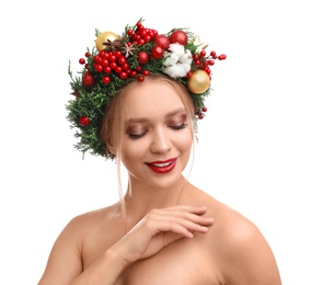 Beautiful young woman wearing Christmas wreath on white background