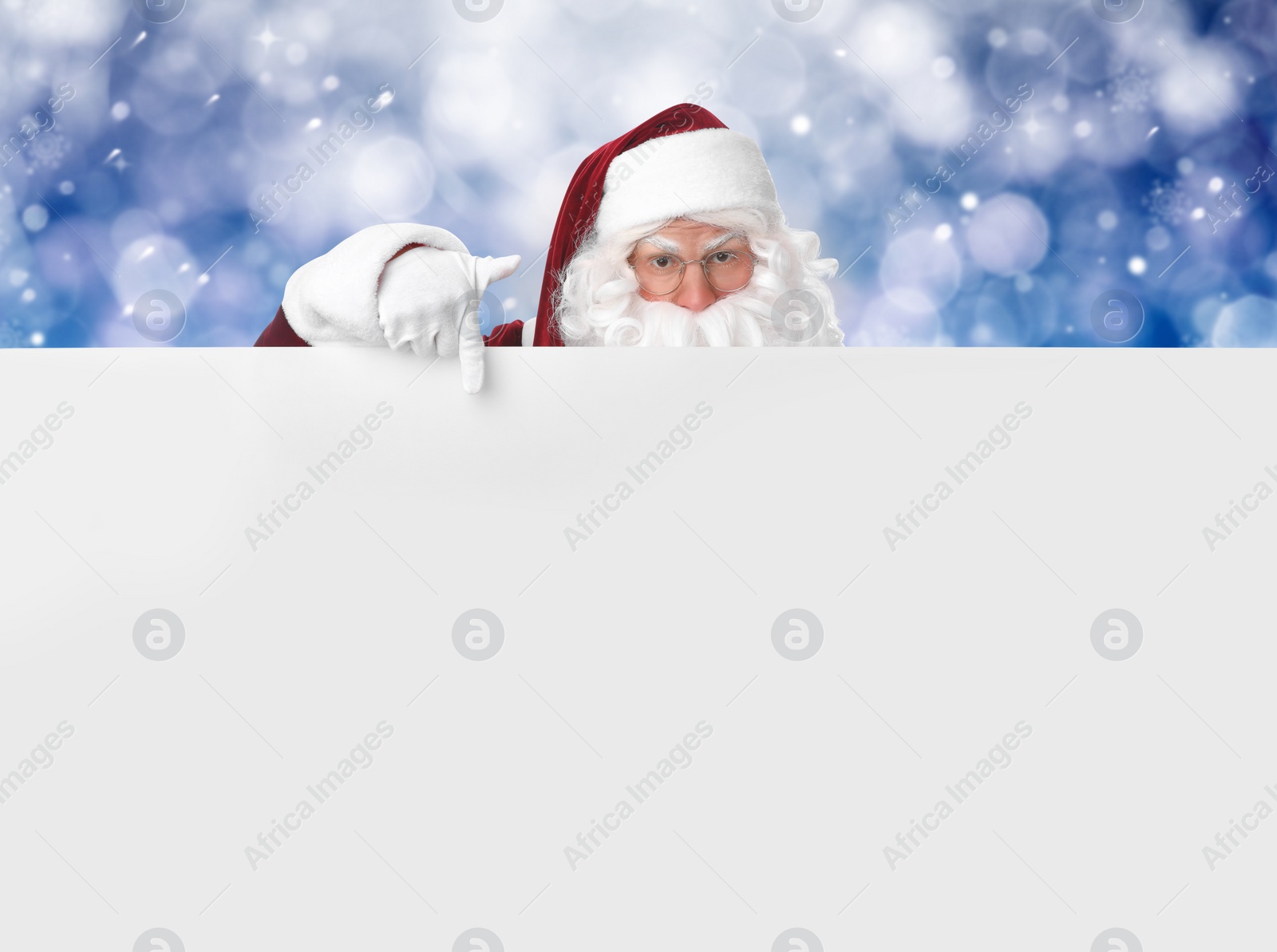 Image of Santa Claus with blank banner on blurred blue background. Space for design