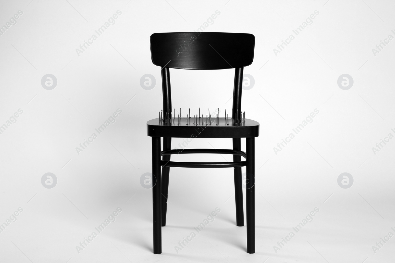 Photo of Chair with iron nails isolated on white. Hemorrhoids concept