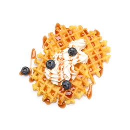 Photo of Delicious waffles with caramel syrup, whipped cream and blueberries on white background, top view