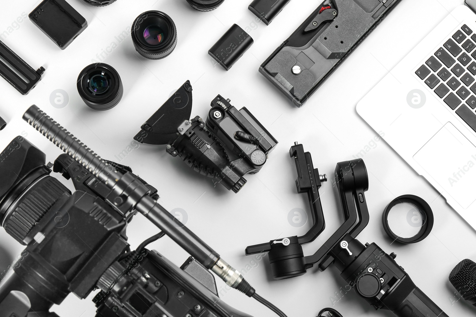 Photo of Flat lay composition with video camera and other equipment on white background