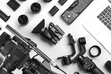 Flat lay composition with video camera and other equipment on white background