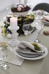 Beautiful Easter table setting with floral decor indoors