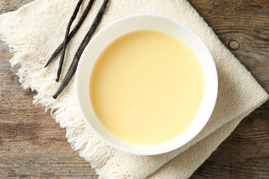 Bowl with condensed milk served on table, top view. Dairy products