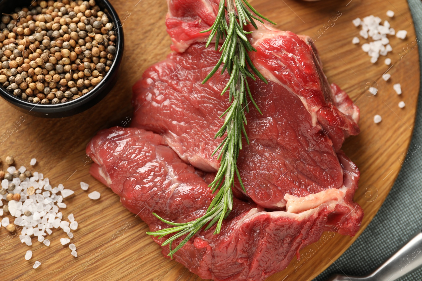 Photo of Piece of raw beef meat and spices on table, above view