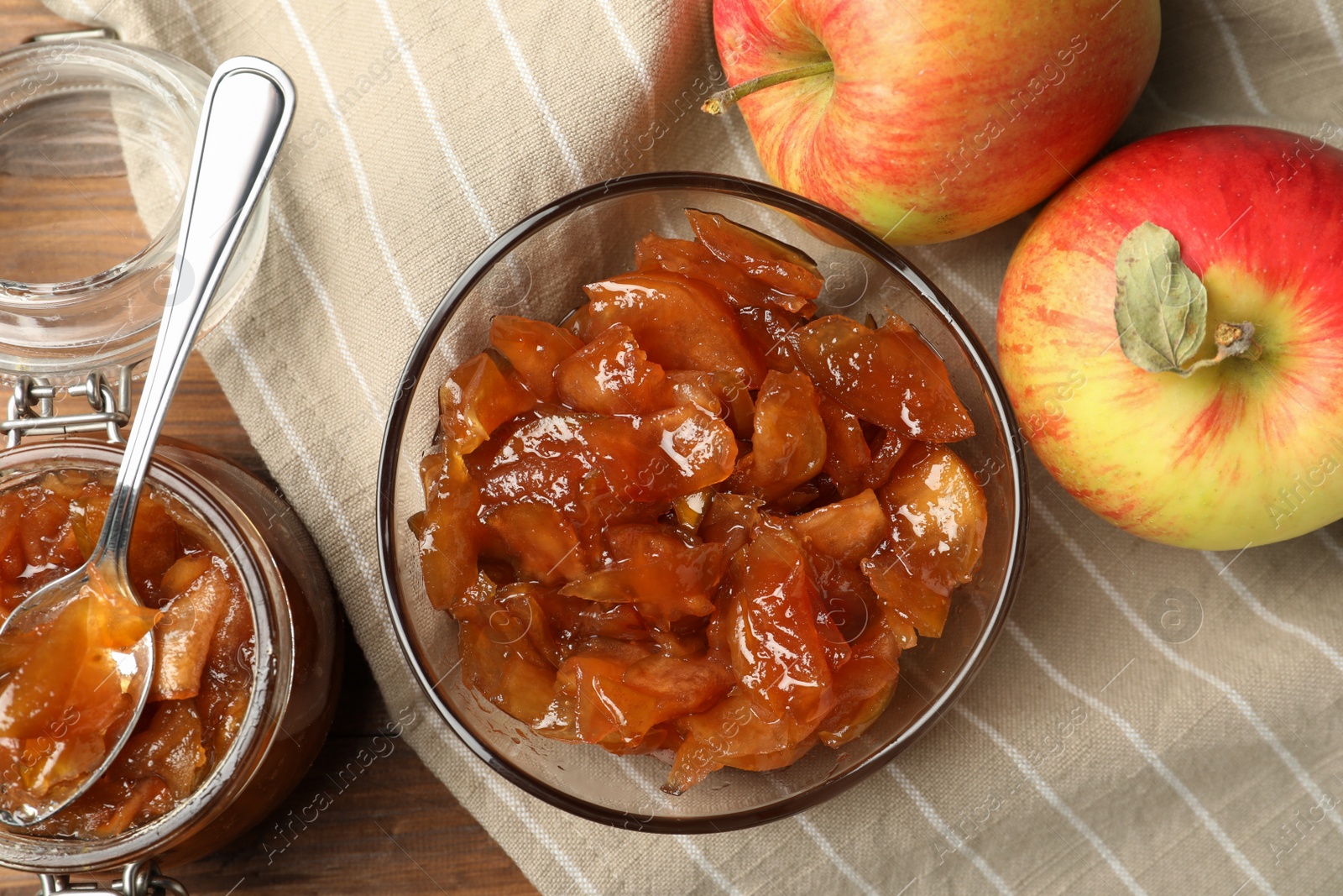 Photo of Tasty apple jam and fresh fruits on wooden table, flat lay