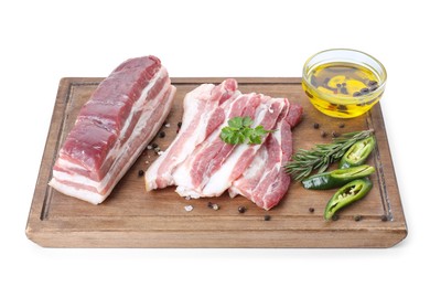 Photo of Pieces of raw pork belly, chili pepper, peppercorns, rosemary and parsley isolated on white