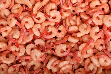 Photo of Fresh raw shrimps as background, top view. Wholesale market