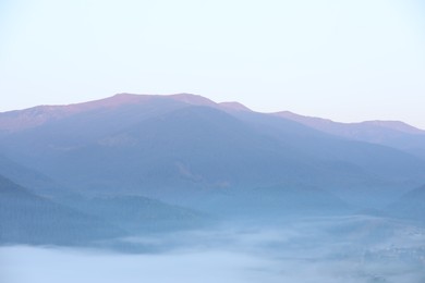 Photo of Beautiful view of fog in mountains during sunrise