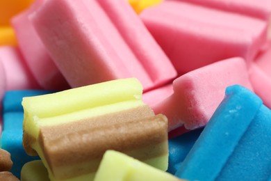 Different tasty colorful bubble gums as background, closeup