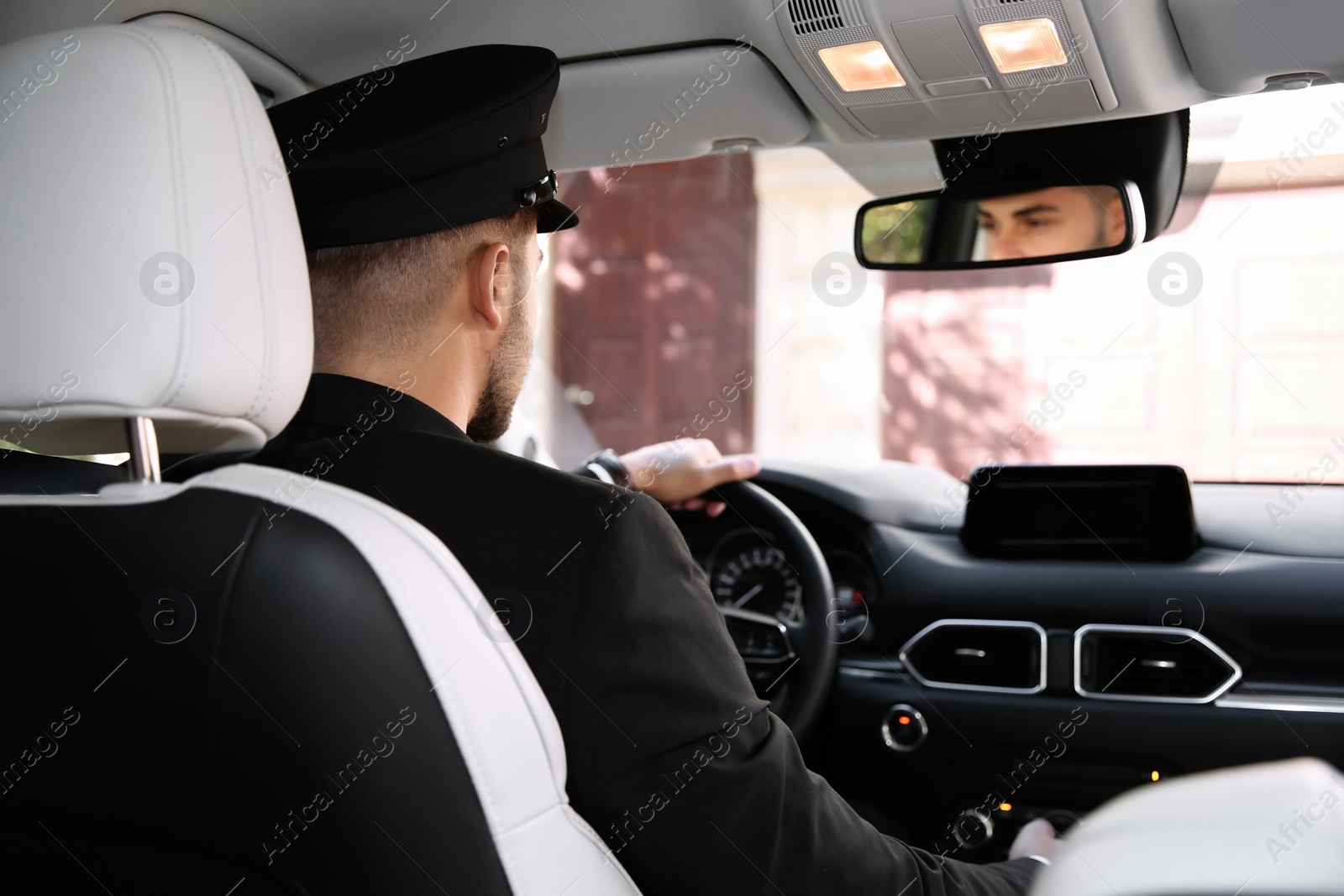 Photo of Young driver in luxury car. Chauffeur service